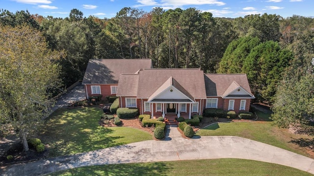 view of front of house with covered porch and a front yard