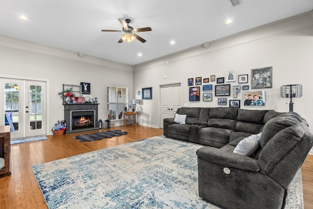 114 Bluffton Rd, Dothan, AL 36301 - living area featuring wood finished floors, a ceiling fan, french doors, a lit fireplace, and recessed lighting