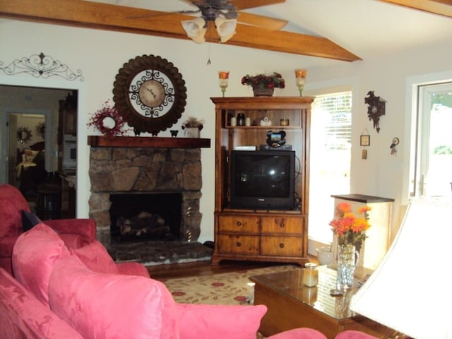 living room with lofted ceiling with beams, ceiling fan, and a fireplace