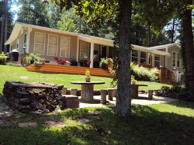 view of yard with a patio area and a wooden deck