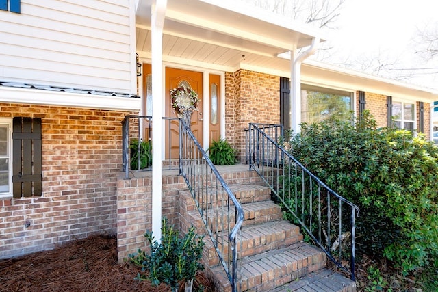 doorway to property with brick siding