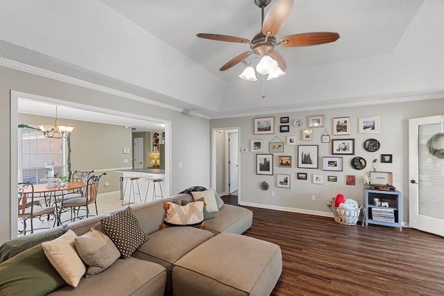 living room with a raised ceiling, crown molding, dark hardwood / wood-style flooring, and ceiling fan with notable chandelier