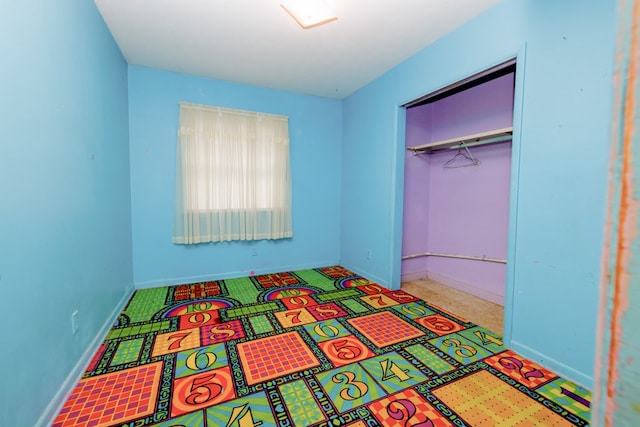 bedroom featuring a closet and baseboards