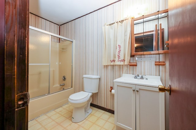 full bath with vanity, wallpapered walls, tile patterned floors, toilet, and combined bath / shower with glass door