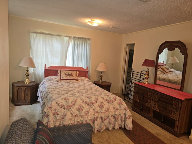 bedroom with light carpet and a textured ceiling