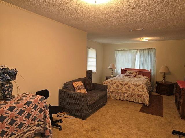 bedroom with a textured ceiling and light colored carpet