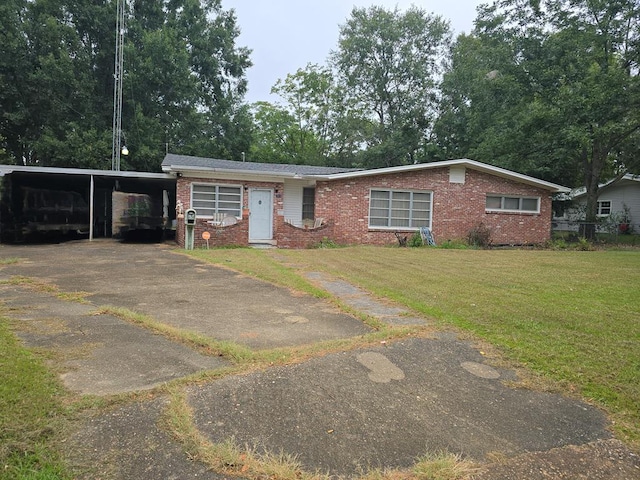 view of front of home with a front lawn and a carport