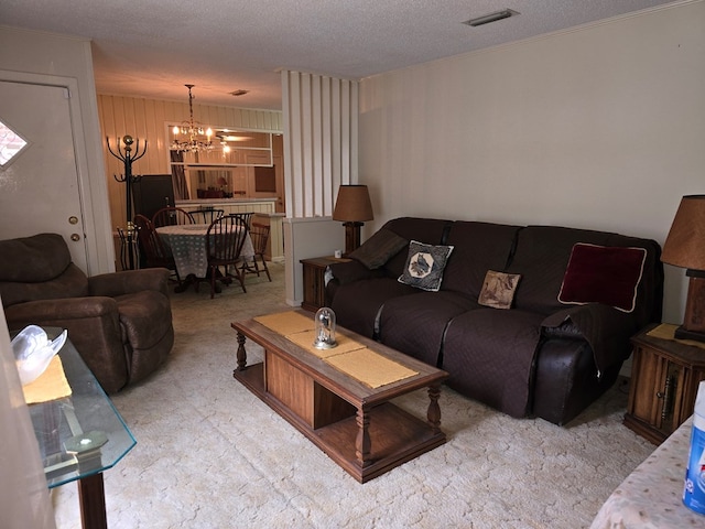 living room featuring a textured ceiling and a notable chandelier