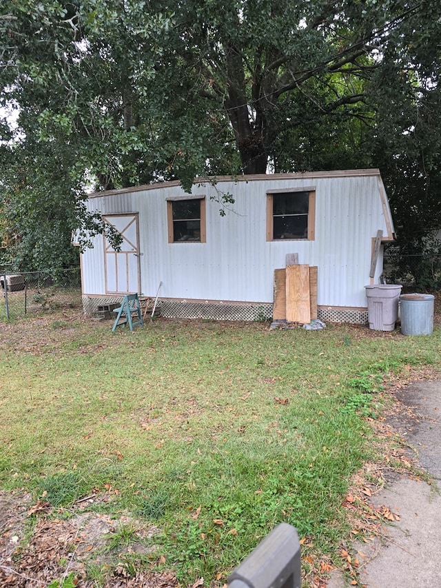 view of outdoor structure with a lawn