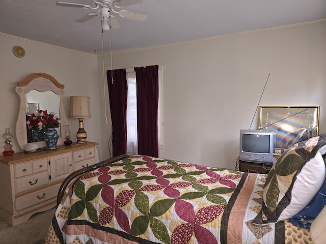 carpeted bedroom with ceiling fan and crown molding