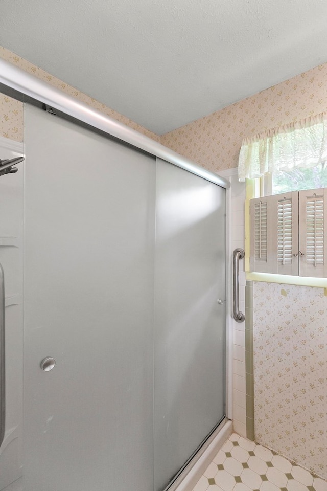 155 Sharon Ln, Ozark, AL 36360 - full bathroom featuring tile patterned floors, a stall shower, and wallpapered walls