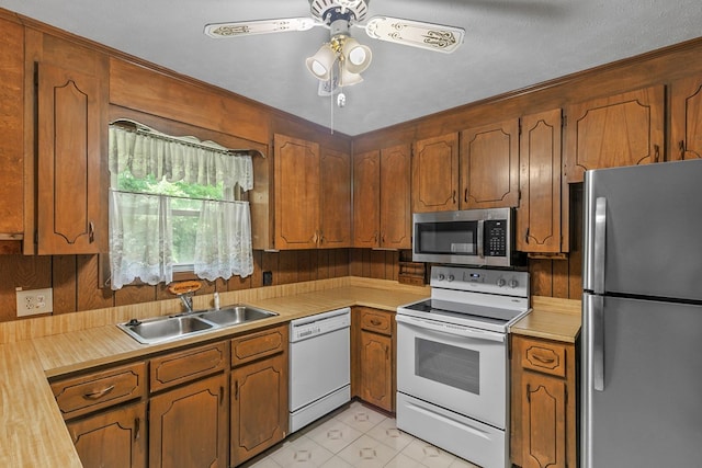 155 Sharon Ln, Ozark, AL 36360 - kitchen with stainless steel appliances, a sink, light countertops, and brown cabinets