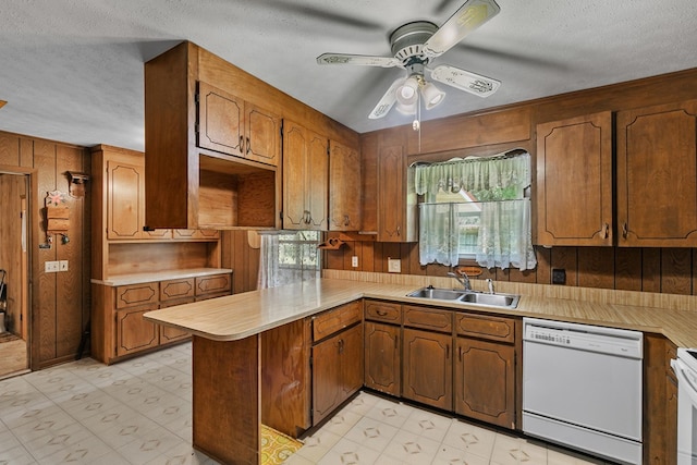 155 Sharon Ln, Ozark, AL 36360 - kitchen featuring white dishwasher, a sink, a peninsula, a textured ceiling, and light countertops