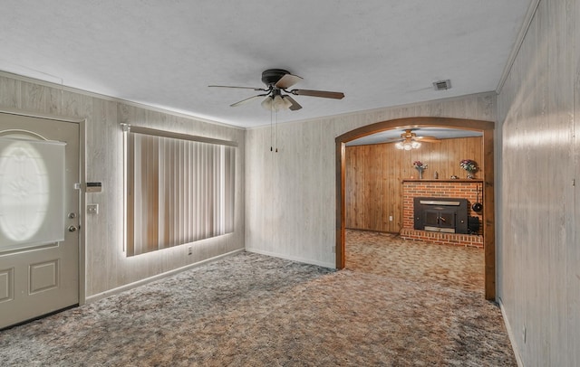 155 Sharon Ln, Ozark, AL 36360 - unfurnished living room with a ceiling fan, arched walkways, carpet flooring, crown molding, and baseboards