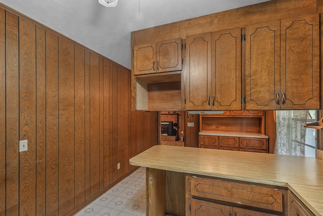 155 Sharon Ln, Ozark, AL 36360 - kitchen featuring wooden walls, brown cabinets, light countertops, and light floors