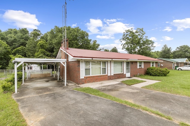155 Sharon Ln, Ozark, AL 36360 - ranch-style house featuring brick siding, driveway, metal roof, and a carport