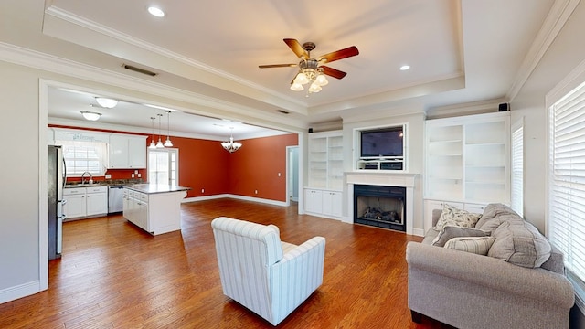 living room with dark wood-type flooring, a healthy amount of sunlight, and sink