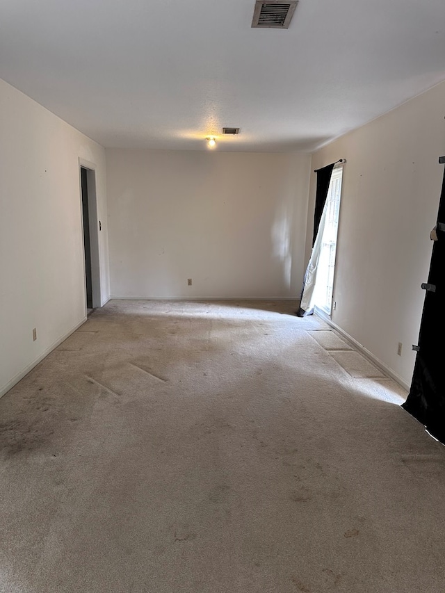 spare room with light carpet