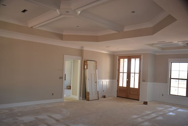 empty room with french doors, a tray ceiling, and crown molding