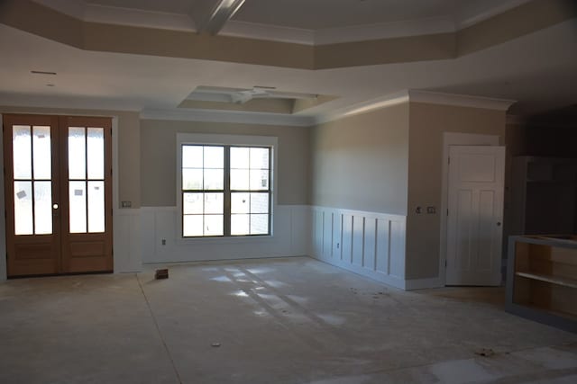 spare room with french doors, a raised ceiling, and ornamental molding