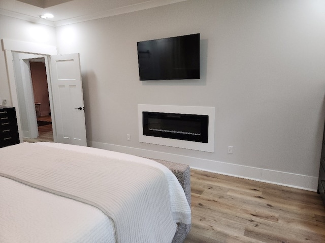 512 Gladstone Way, Dothan, AL 36305 - bedroom featuring wood finished floors, baseboards, and a glass covered fireplace