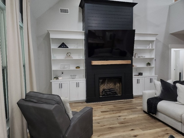 512 Gladstone Way, Dothan, AL 36305 - living area with a glass covered fireplace and light wood-style floors