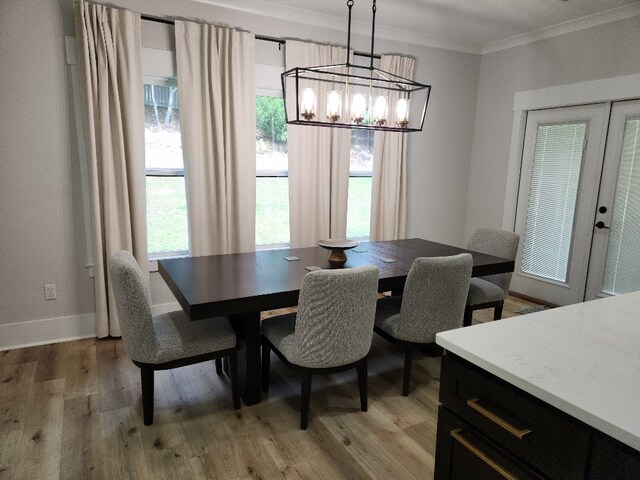 512 Gladstone Way, Dothan, AL 36305 - dining space with ornamental molding, light wood-style flooring, a chandelier, and baseboards
