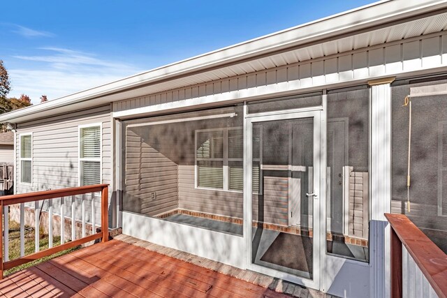 wooden deck featuring a sunroom