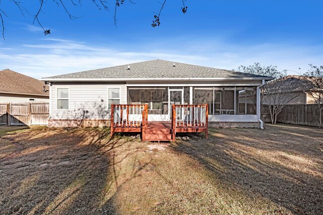 back of house with a sunroom, a yard, and a wooden deck