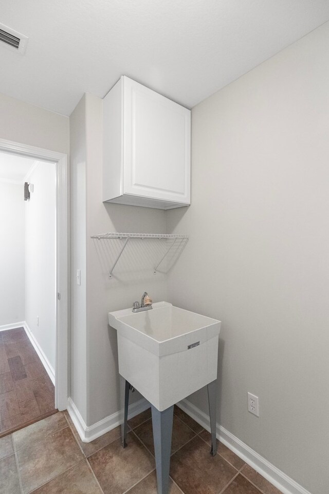 laundry area featuring cabinets