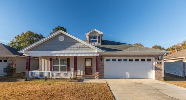 view of front facade featuring a front lawn, a porch, and a garage