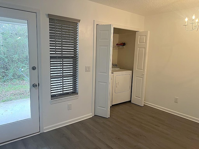 washroom with dark wood-style flooring, a textured ceiling, washer / dryer, laundry area, and baseboards