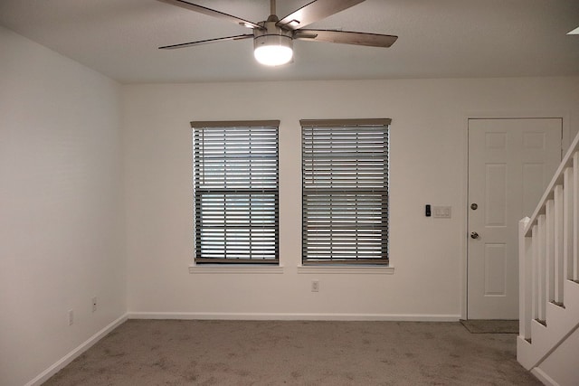 carpeted empty room featuring ceiling fan