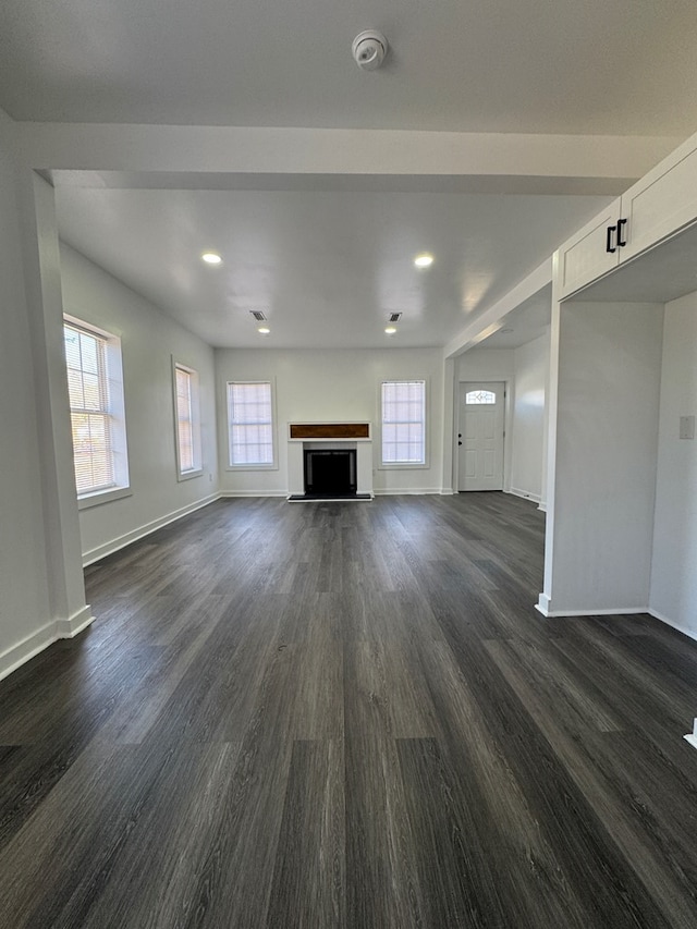 unfurnished living room with dark hardwood / wood-style floors