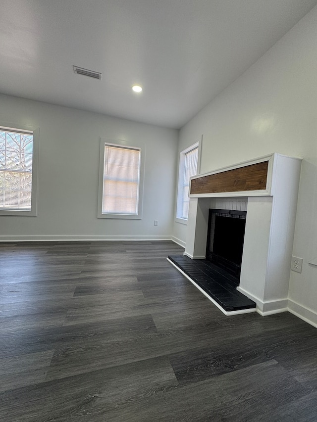 unfurnished living room featuring dark hardwood / wood-style floors