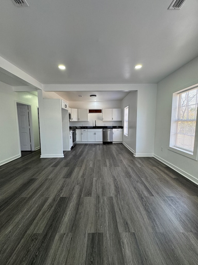 unfurnished living room featuring dark hardwood / wood-style floors