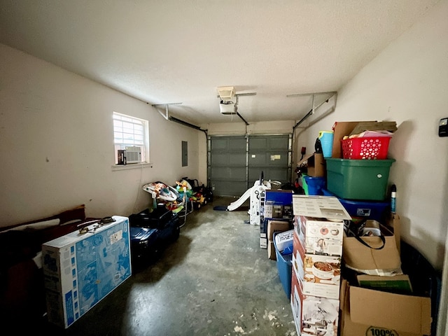 garage featuring electric panel and a garage door opener