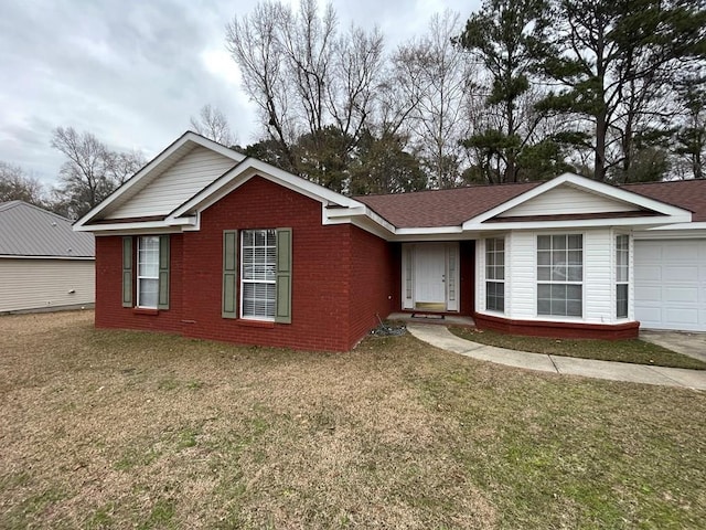 single story home with a front yard and a garage