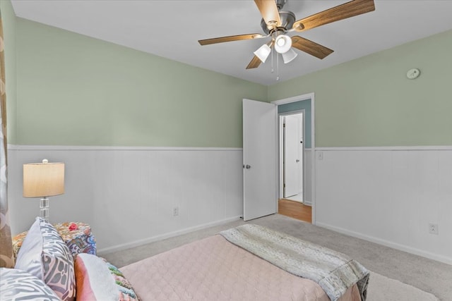 bedroom featuring ceiling fan and light carpet