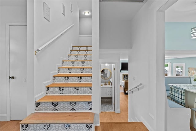 stairs with wood-type flooring