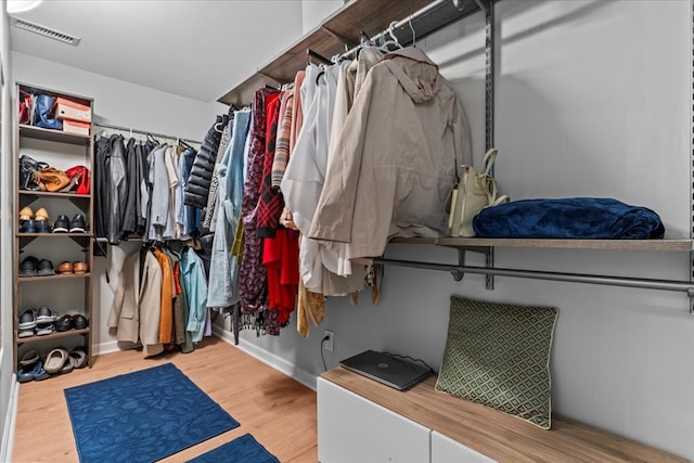 spacious closet with light hardwood / wood-style flooring