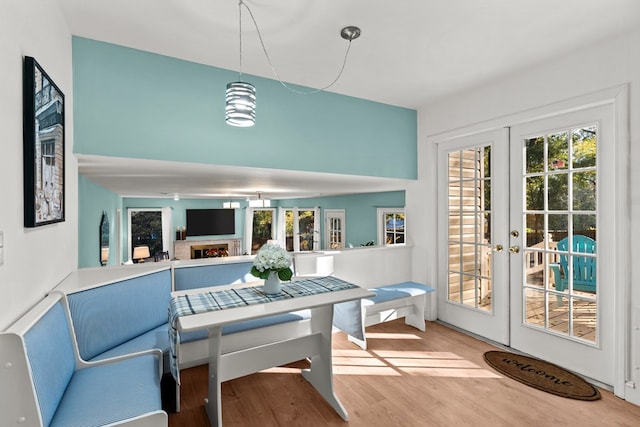 dining space with hardwood / wood-style flooring and french doors