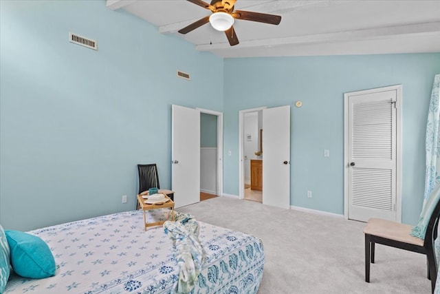 bedroom featuring ceiling fan, light carpet, a closet, and lofted ceiling with beams