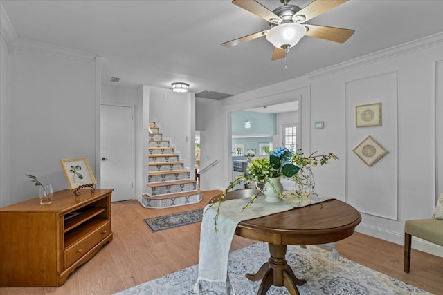 interior space featuring ceiling fan, crown molding, and hardwood / wood-style flooring