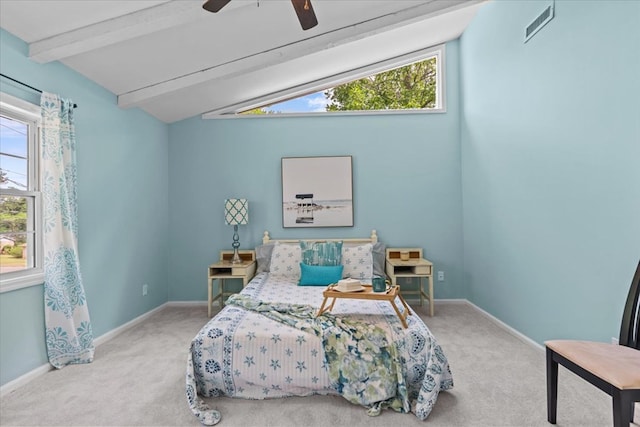 carpeted bedroom featuring ceiling fan and vaulted ceiling with beams