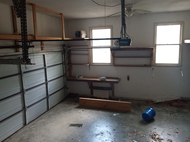garage featuring a garage door opener and a ceiling fan