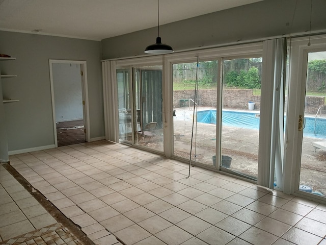 interior space with baseboards and light tile patterned floors