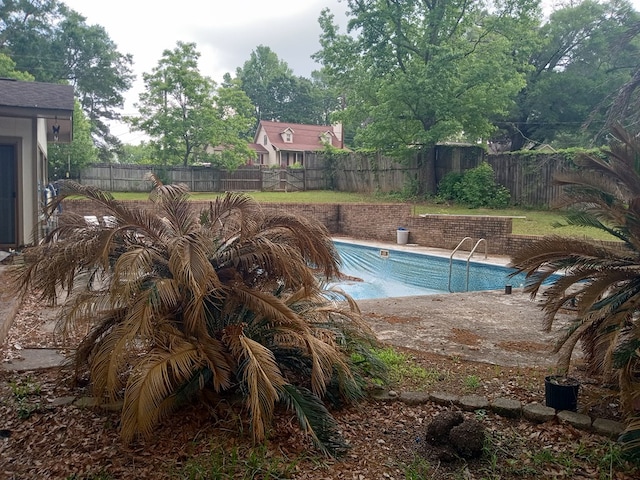 view of pool with a fenced backyard