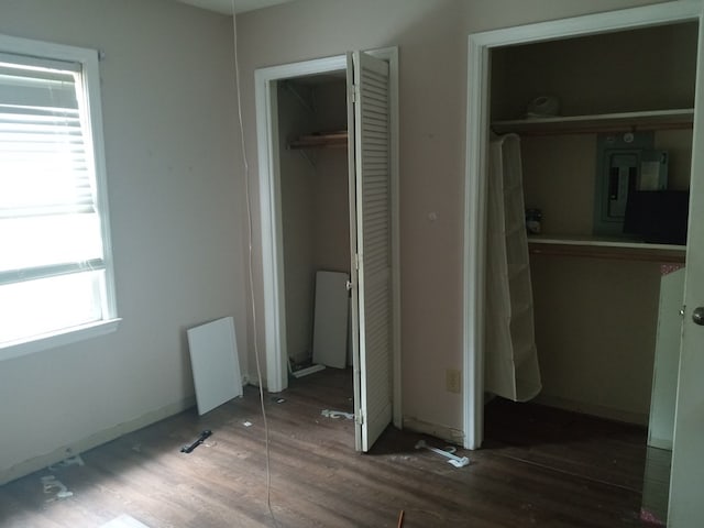 unfurnished bedroom with wood finished floors and a closet