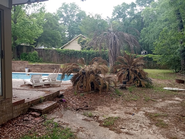 view of yard with a patio, a fenced in pool, and a fenced backyard